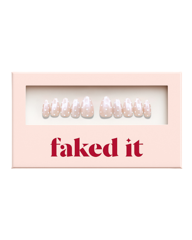White polka dots on a pink chrome base.  Press on nails inside press on nail packaging. Chrome press on nails.