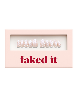 White polka dots on a pink chrome base.  Press on nails inside press on nail packaging. Chrome press on nails.