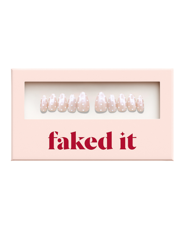 White polka dots on a pink chrome base.  Press on nails inside press on nail packaging. Chrome press on nails.